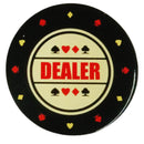 Poker chip with 'DEALER' text and card suits on a black background