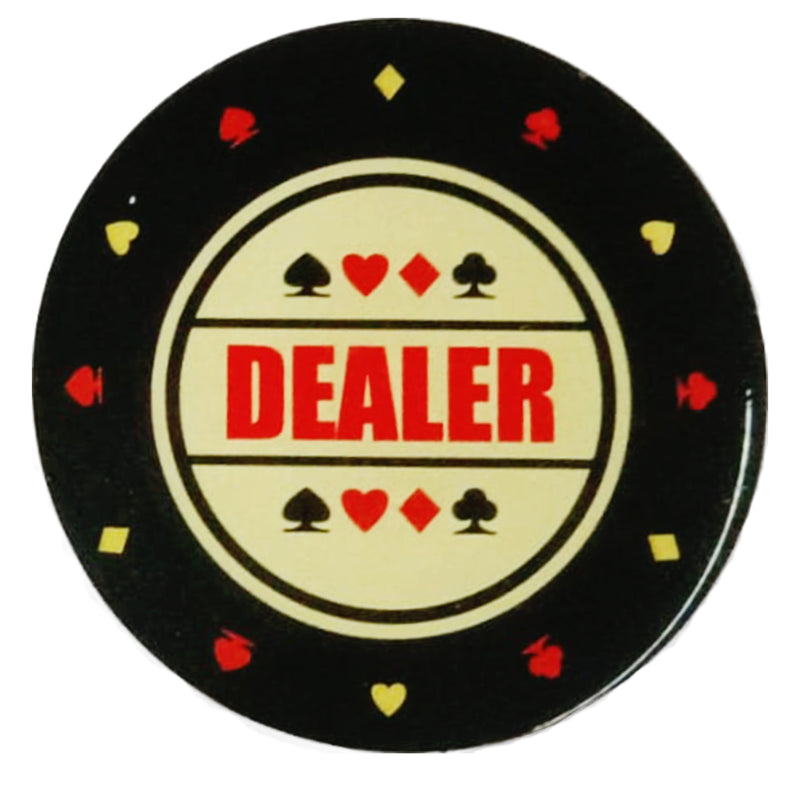Poker chip with 'DEALER' text and card suits on a black background